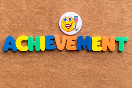 achievement colorful word on the wooden background