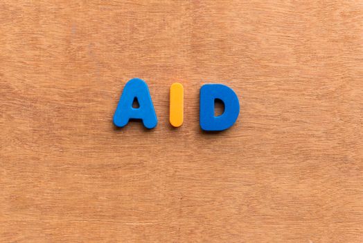 aid colorful word on the wooden background