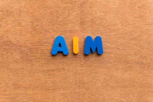 aim colorful word on the wooden background