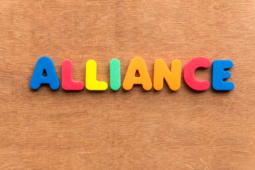 alliance colorful word on the wooden background