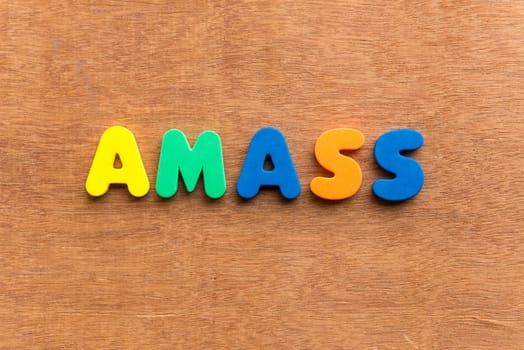 amass colorful word on the wooden background