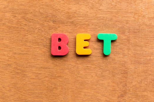 bet colorful word on the wooden background