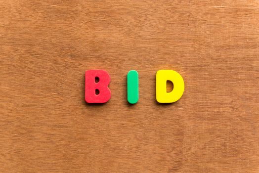bid colorful word on the wooden background