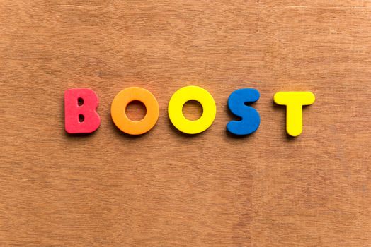 boost colorful word on the wooden background