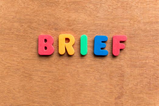 brief colorful word on the wooden background