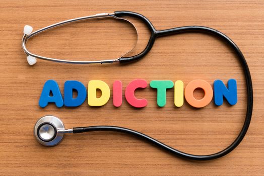 addiction colorful word on the wooden background