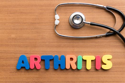 arthritis colorful word on the wooden background