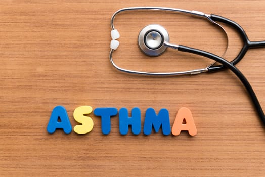 asthma colorful word on the wooden background