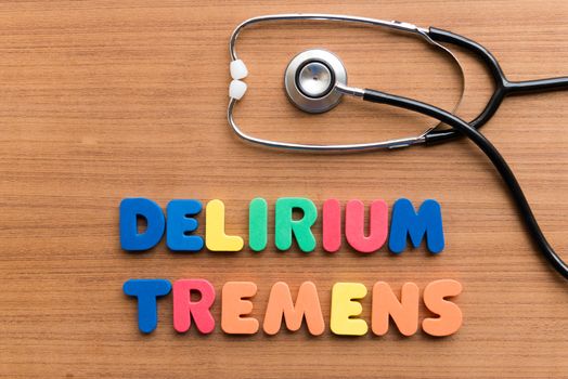 DELIRIUM TREMENS colorful word on the wooden background