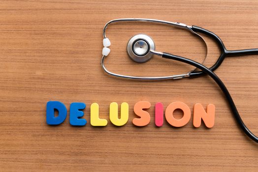 DELUSION colorful word on the wooden background