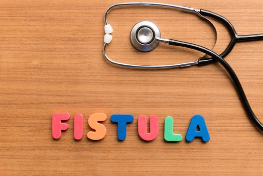 fistula colorful word on the wooden background