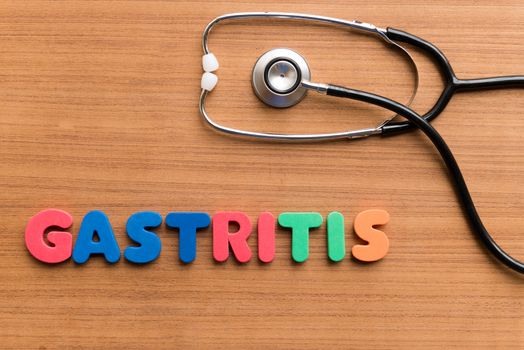 gastritis colorful word on the wooden background