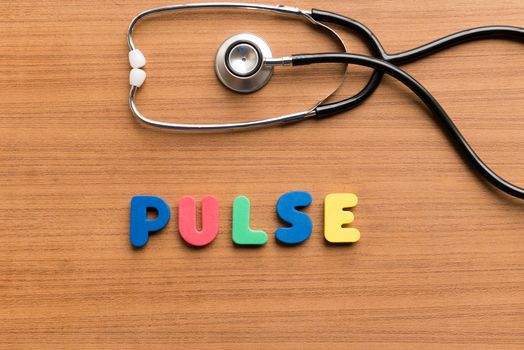 colorful pulse on the wooden background