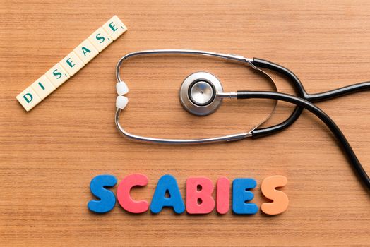 colorful scabies word on the wooden background