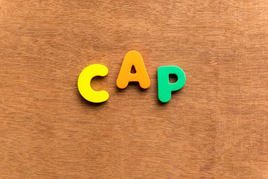 cap colorful word on the wooden background