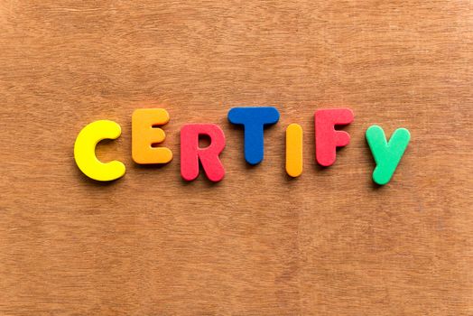 certify colorful word on the wooden background