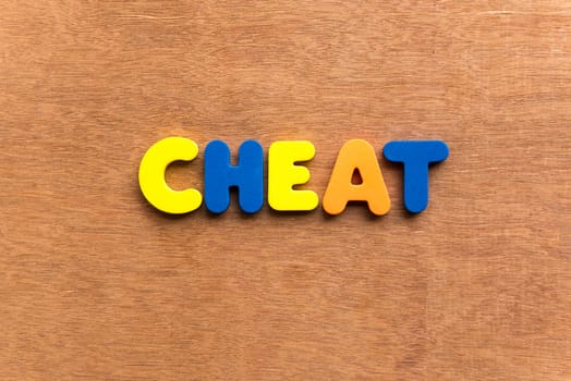 cheat colorful word on the wooden background