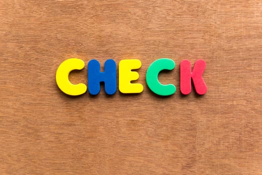 check colorful word on the wooden background