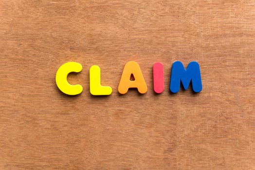 claim colorful word on the wooden background