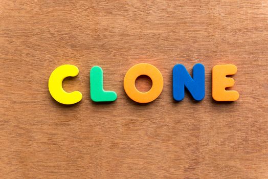 clone colorful word on the wooden background