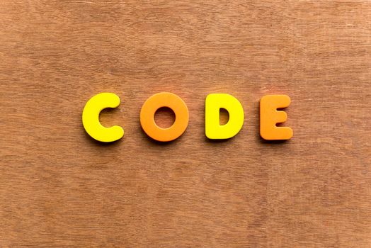 code colorful word on the wooden background