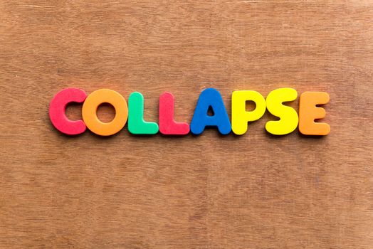 collapse colorful word on the wooden background