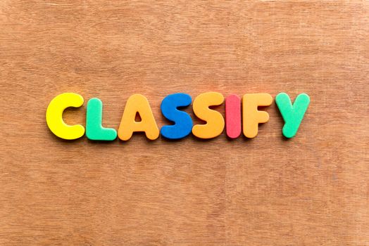 classify colorful word on the wooden background