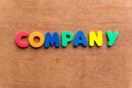 company colorful word on the wooden background