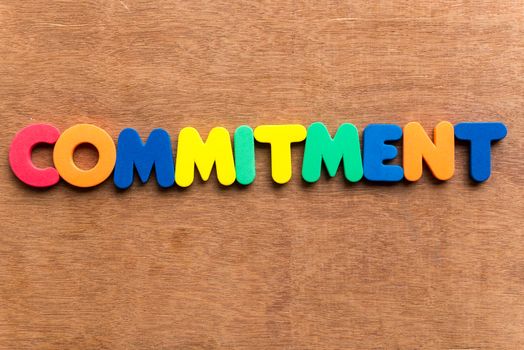 commitment colorful word on the wooden background