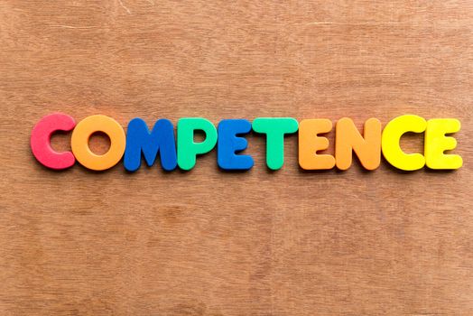 competence colorful word on the wooden background