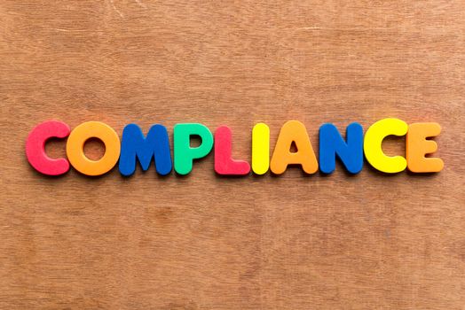 compliance colorful word on the wooden background