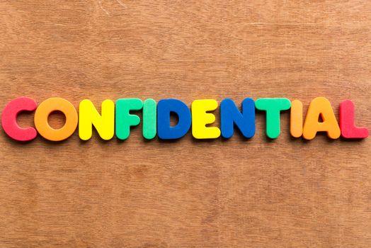 confidential colorful word on the wooden background