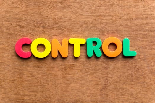 control colorful word on the wooden background