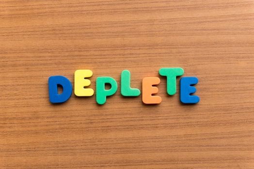 deplete colorful word on the wooden background