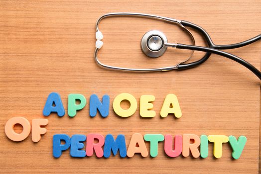 Apnoea of prematurity colorful word with stethoscope on the wooden background