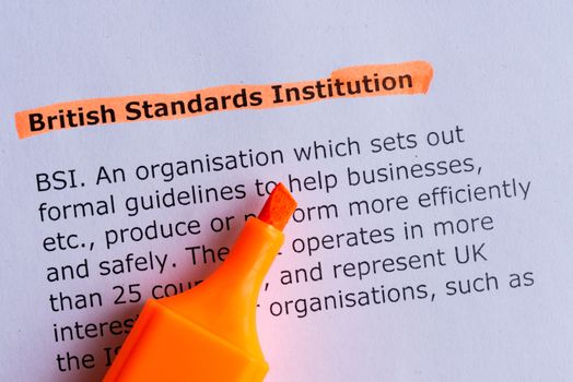 british standards institution word highlighted on the white paper