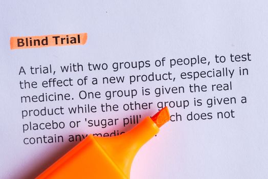 blind trial word highlighted on the white paper