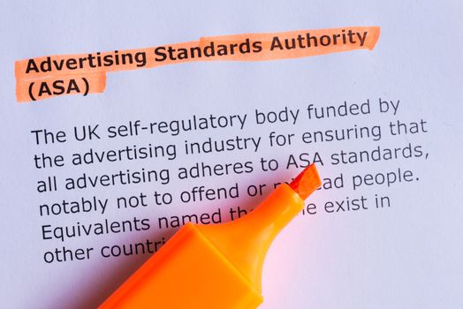 advertising standards authority word highlighted on the white paper