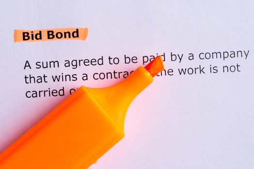 bid bond word highlighted on the white paper
