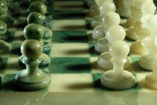 chessboard and alabaster chess on a black background