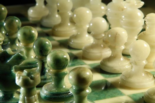 chessboard and alabaster chess on a black background