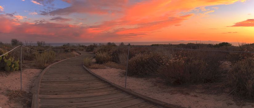 Boardwalk at Crystal Cove beach in California at sunset in the summer