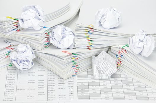 Bankruptcy of house with paper ball on pile overload of paperwork on finance account.