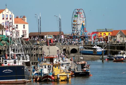 SOUTH BAY HARBOR, SCARBOROUGH, NORTH YORKSHIRE, ENGLAND - 19th of May 2014: Tourists enjoying a day out in Scarborough resort on the 19th of May 2014 This is a popular and tourist destination.