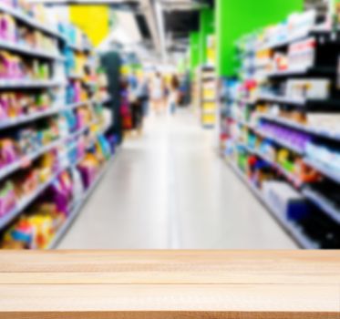 Wooden board empty table in front of blurred background. Perspective light wood over blur in supermarket - can be used for display or montage your products. Mock up for display of product.