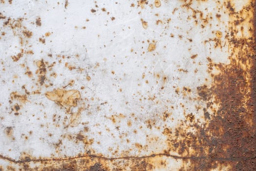 rusty iron surface covered with old chipped grey color paint, which has long been influenced by different climatic conditions