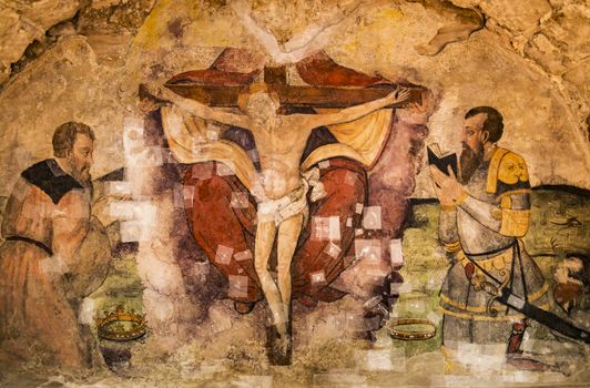Old fresco with Jesus crucifixion inside the medieval church in Basilicata, Italy