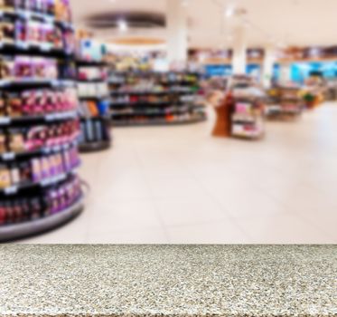 Marble board empty table in front of blurred background. Perspective marble over blur in supermarket - can be used for display or montage your products. Mock up for display of product.