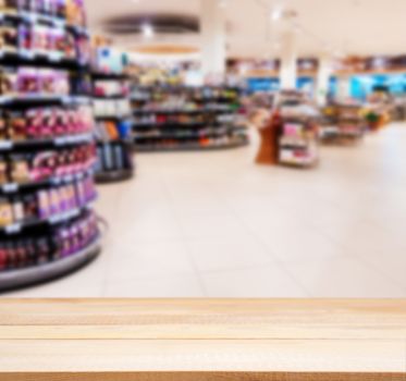 Wooden board empty table in front of blurred background. Perspective light wood over blur in supermarket - can be used for display or montage your products. Mock up for display of product.