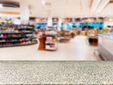 Marble board empty table in front of blurred background. Perspective marble over blur in supermarket - can be used for display or montage your products. Mock up for display of product.